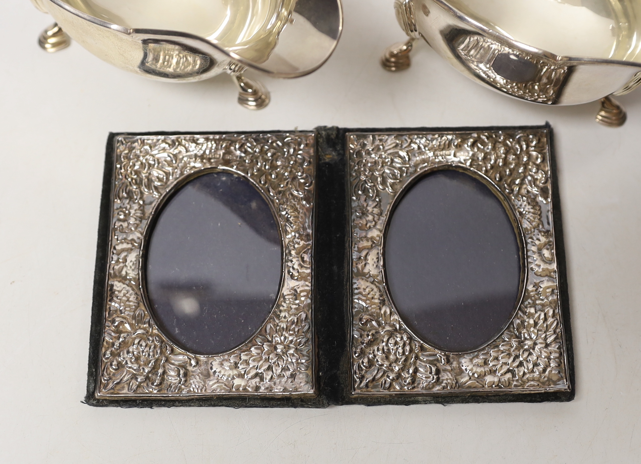 A pair of George V silver sauce boats, Atkin Brothers, Sheffield, 1927, 15.1oz, together with a modern silver mounted double photograph frame.